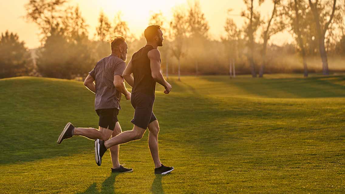 two people run at sunrise