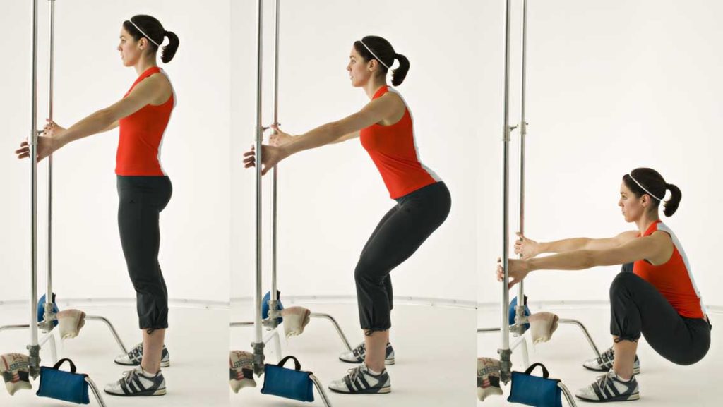 a woman performs a squat