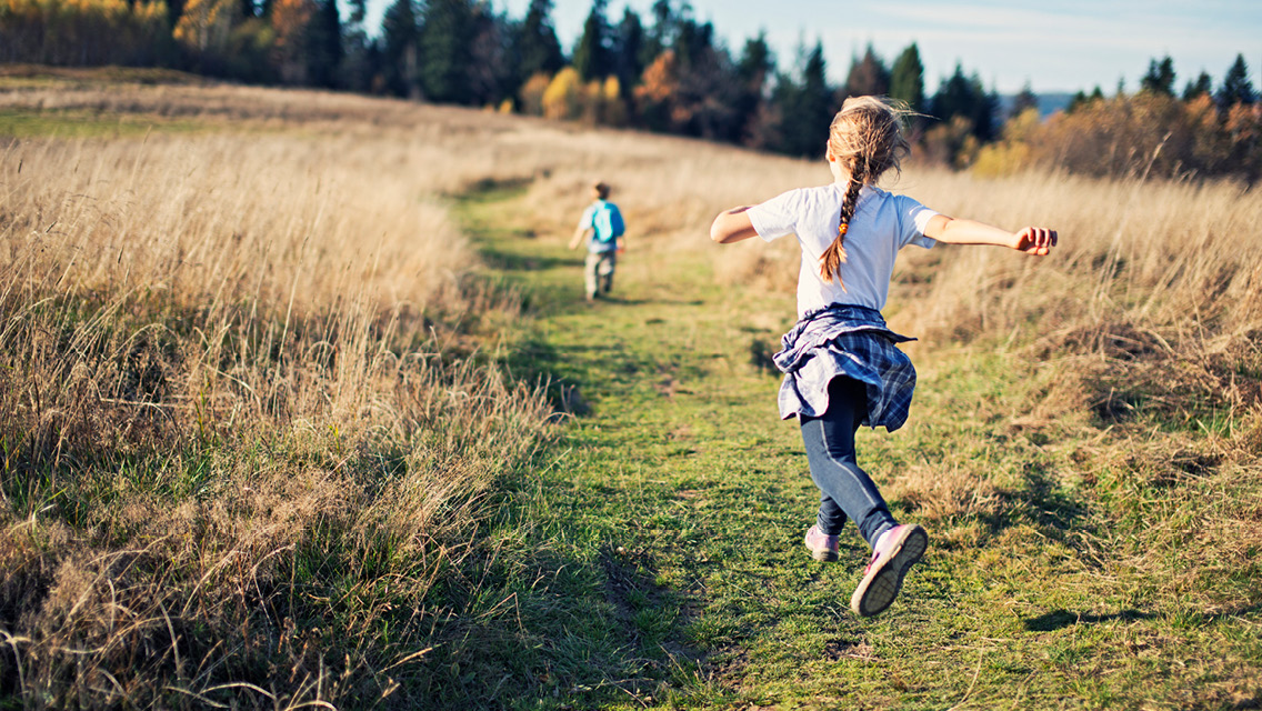 kids run down a nature path