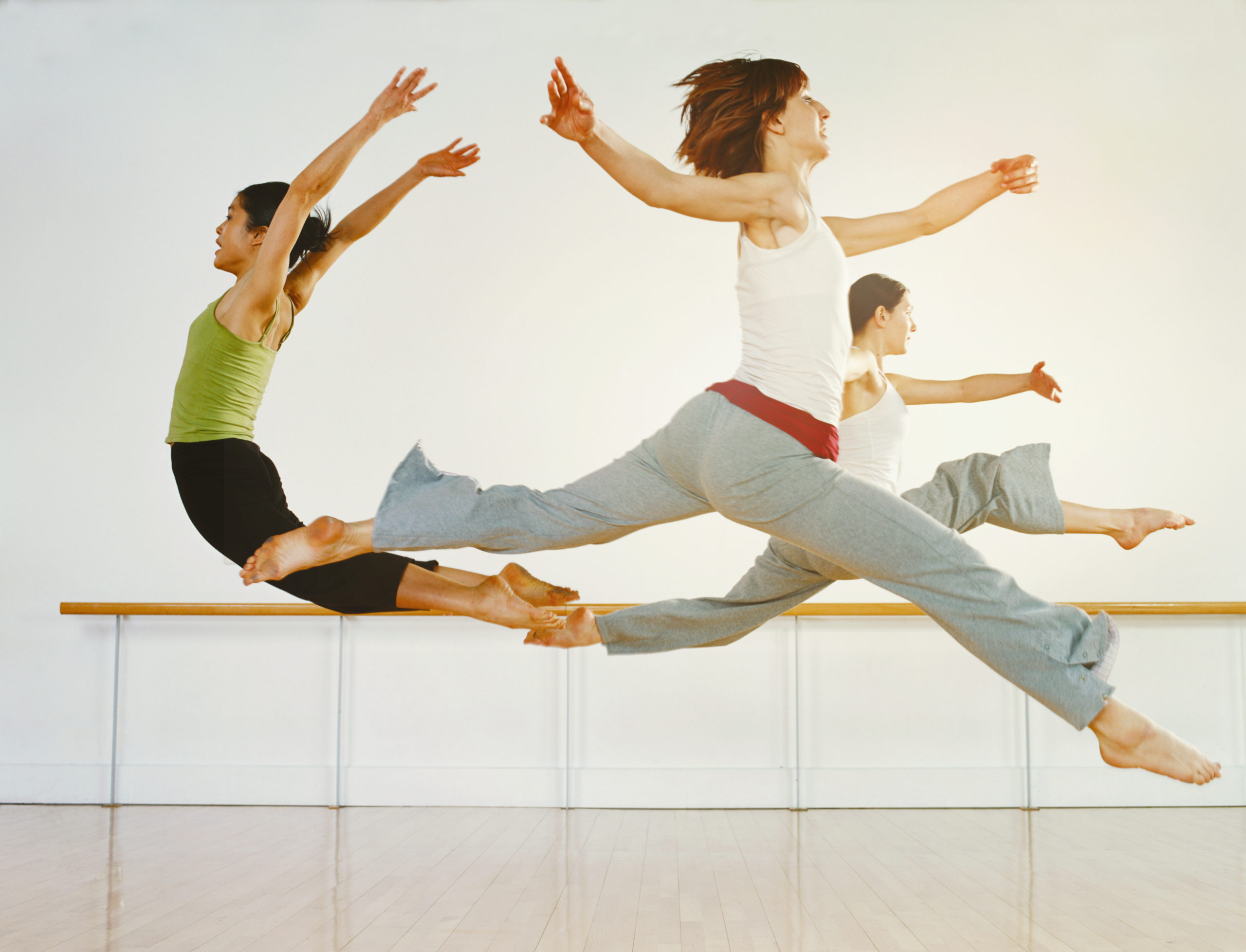 dancers jumping in a studio