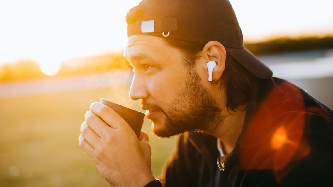 a man sits and drinks coffee before his morning workout