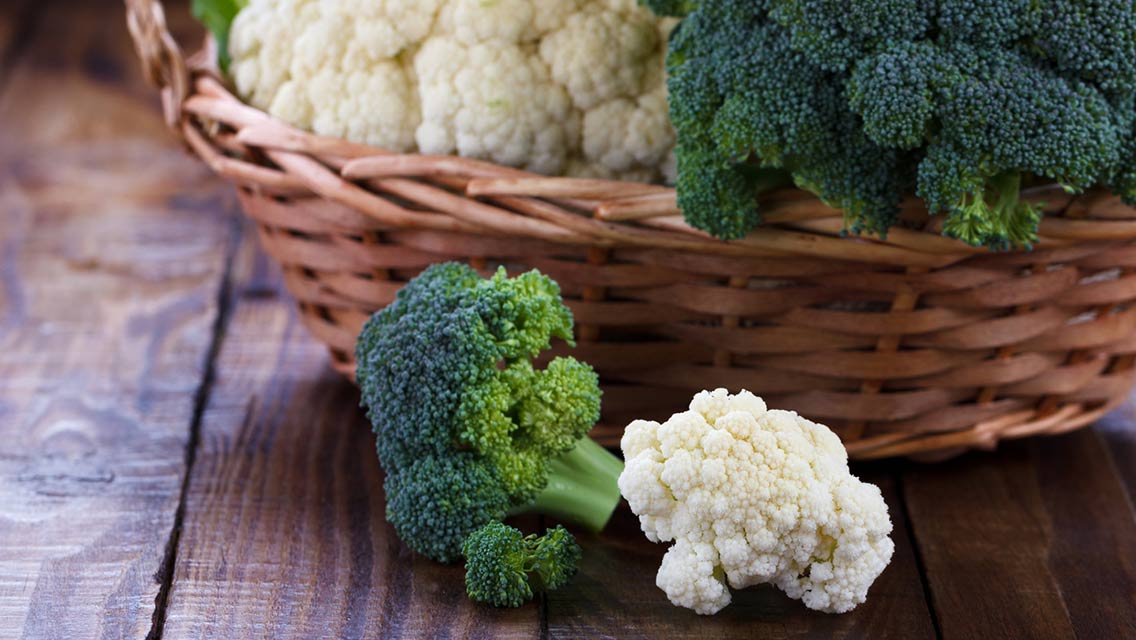 a basket with broccoli and cauliflower