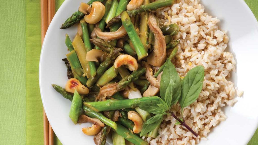 a plate of thai stir fry with brown rice