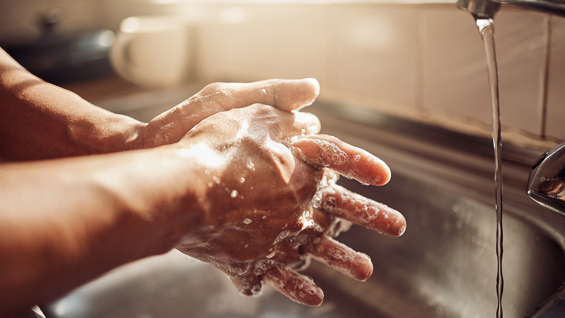 a person washes their hands