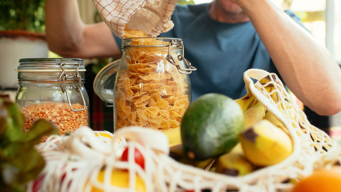 a man prepares and puts away healthy food