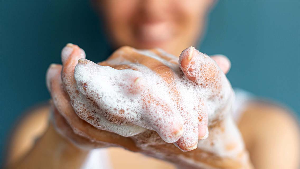 a woman with soapy hands