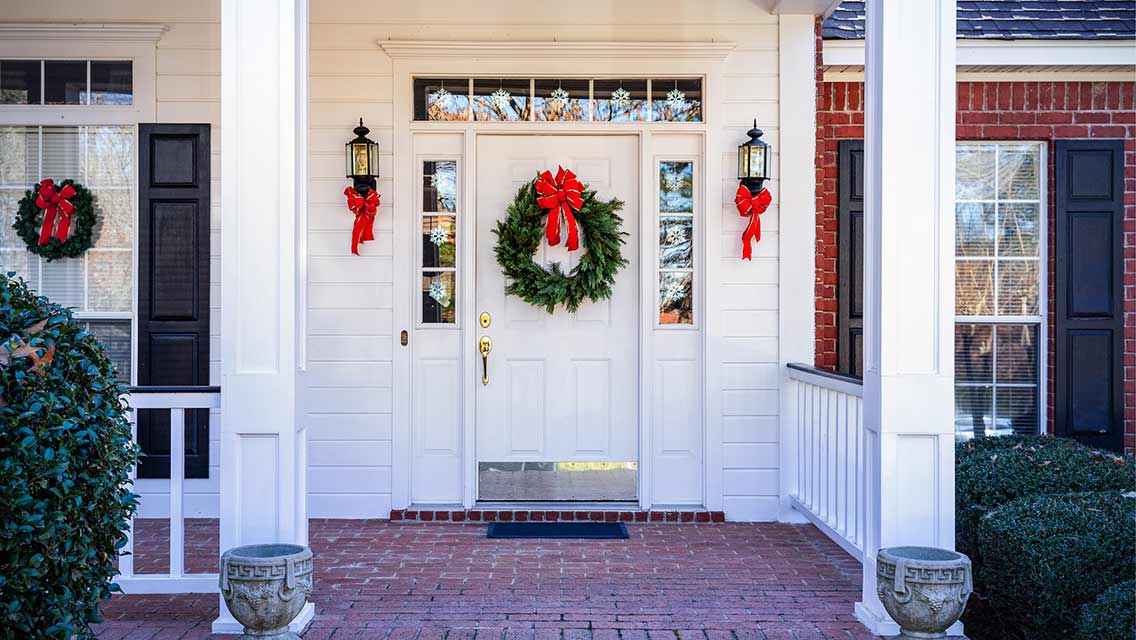 a welcoming front door adorned with a festive wreath