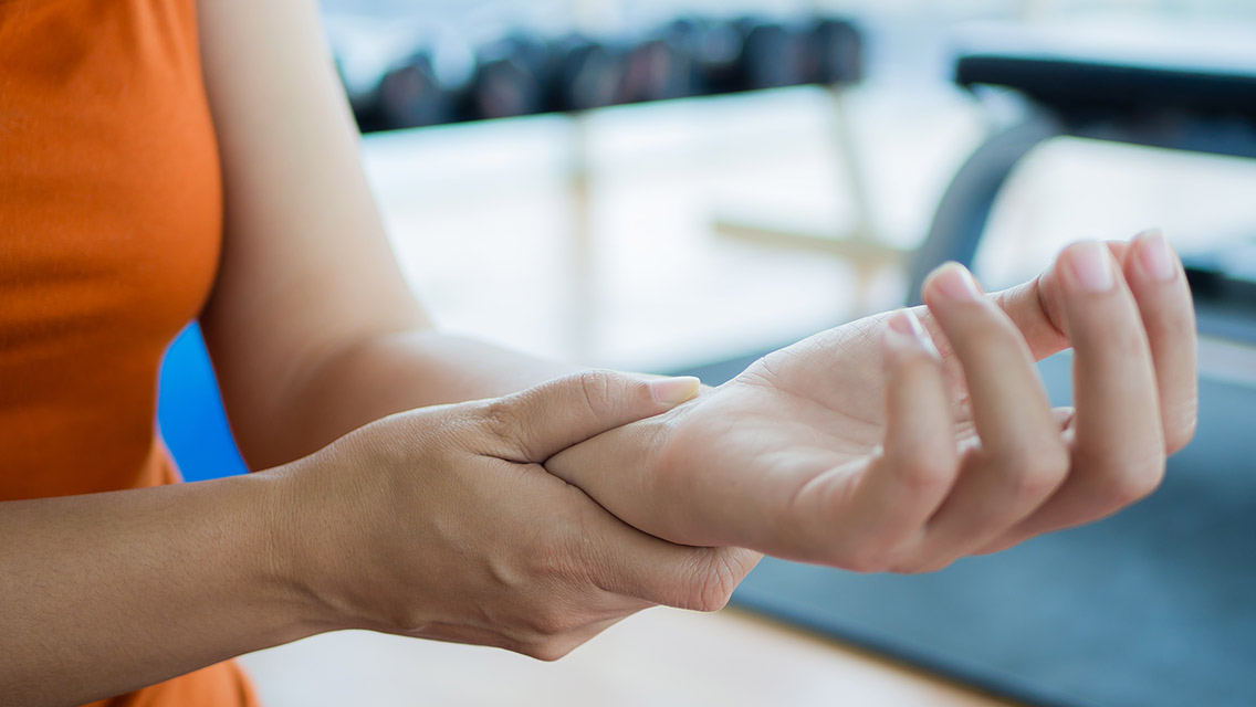 Person holding wrist at gym