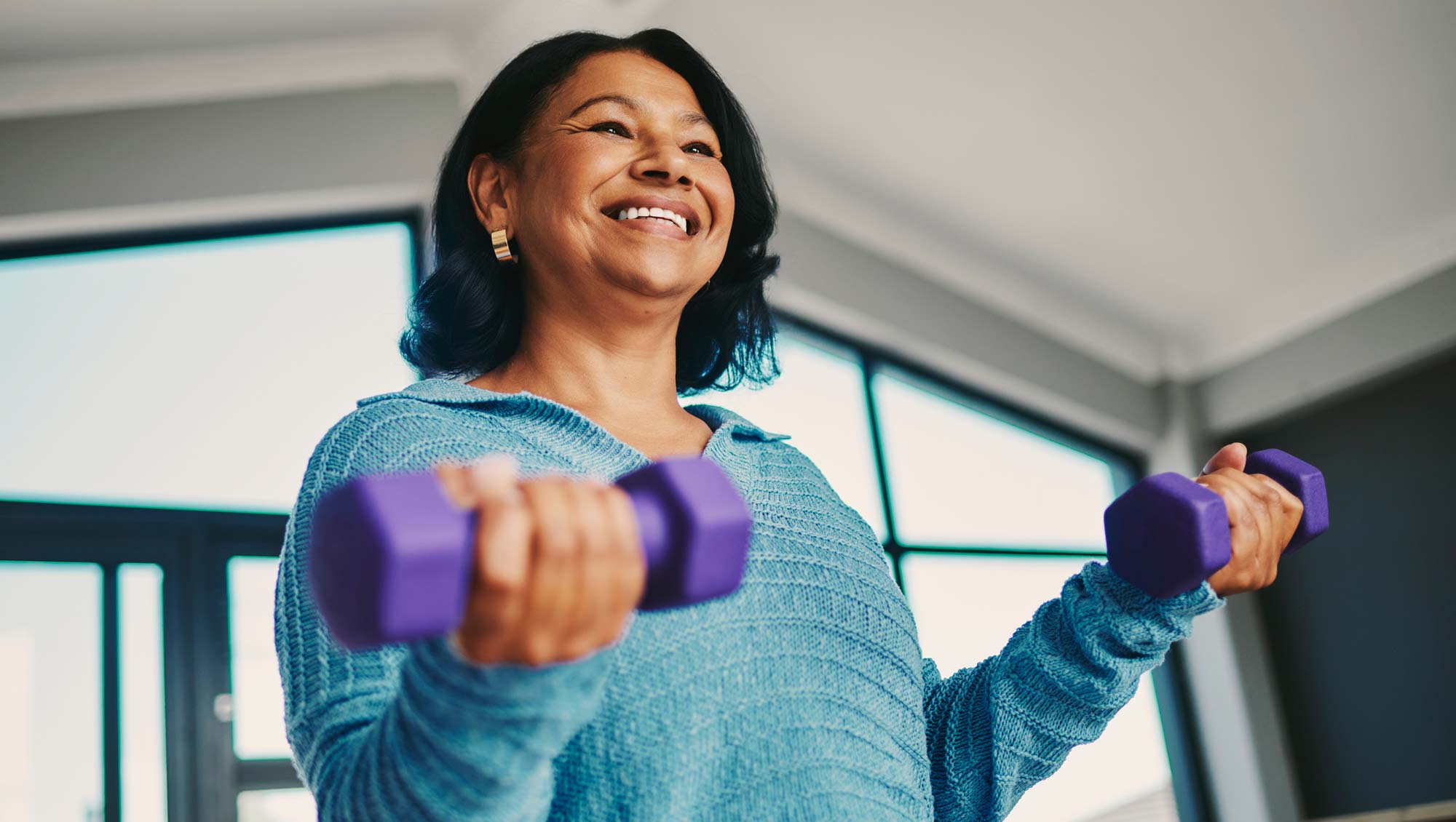 a woman enjoys lifting weights