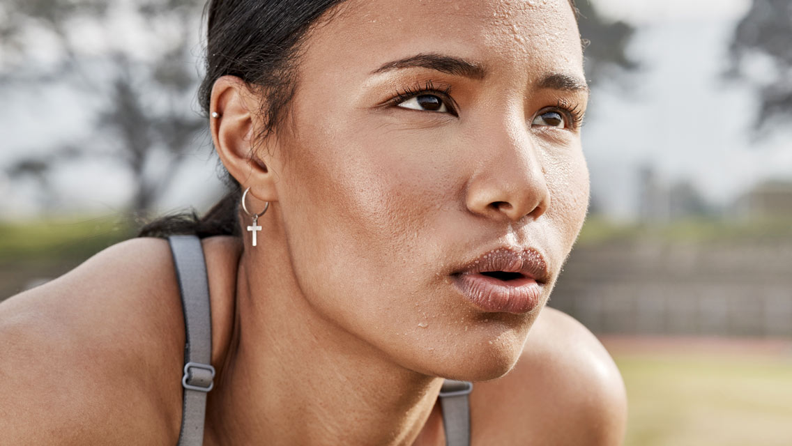 close up of a woman with sweat on her face