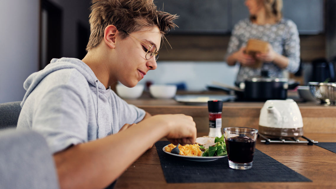 a tween boy eats a healthy breakfast