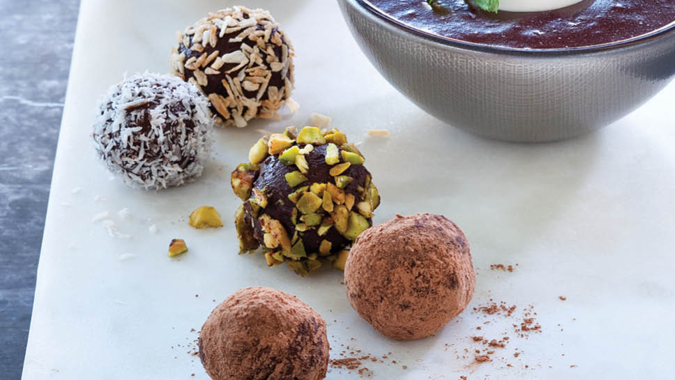 Balls of different flavors of coconut chocolate truffles.