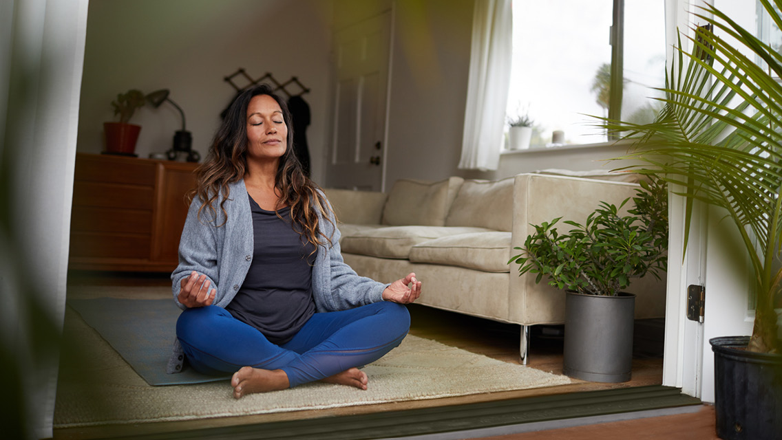 Woman meditating at home
