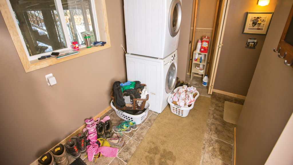 cluttered laundry room before makeover