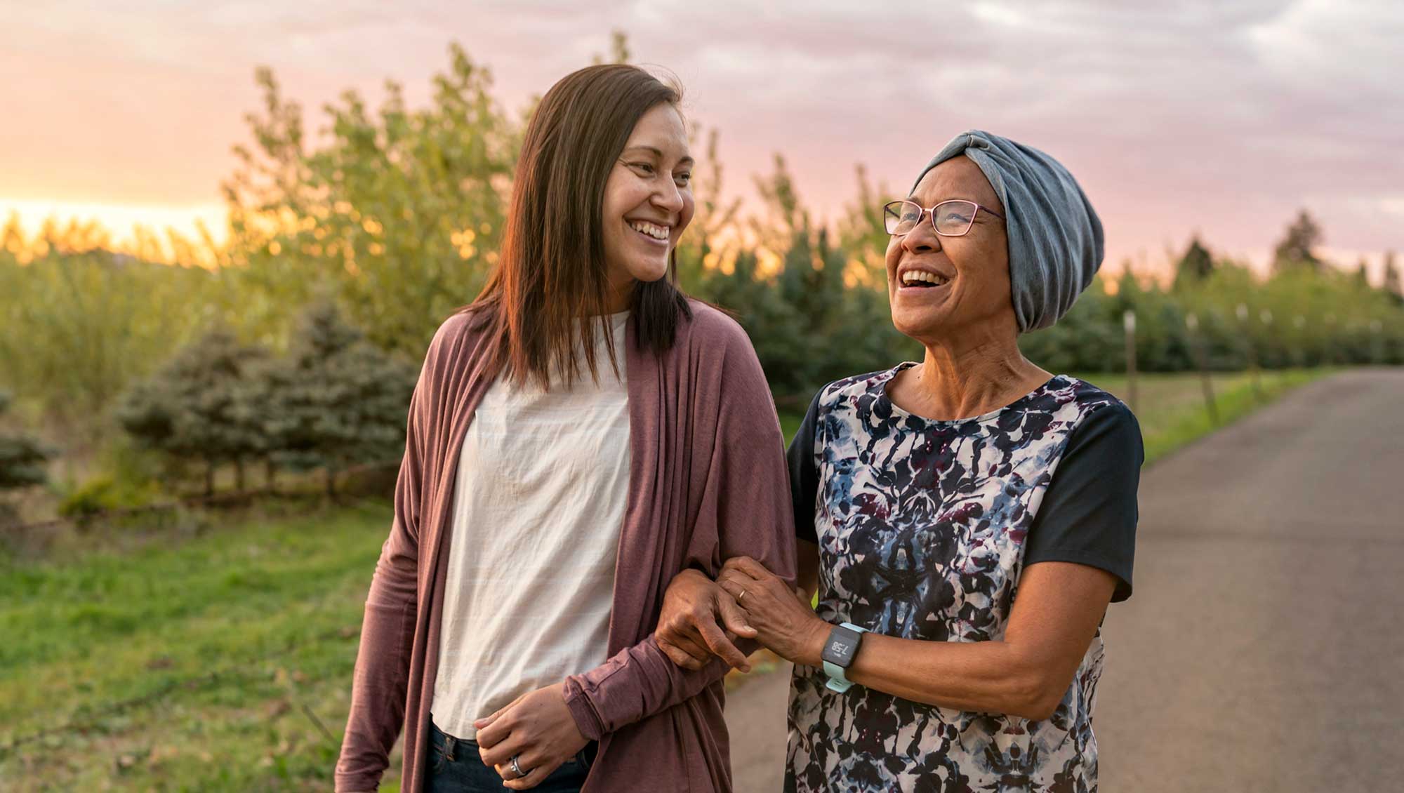 Beautiful mixed race mother and daughter relaxing outdoors together