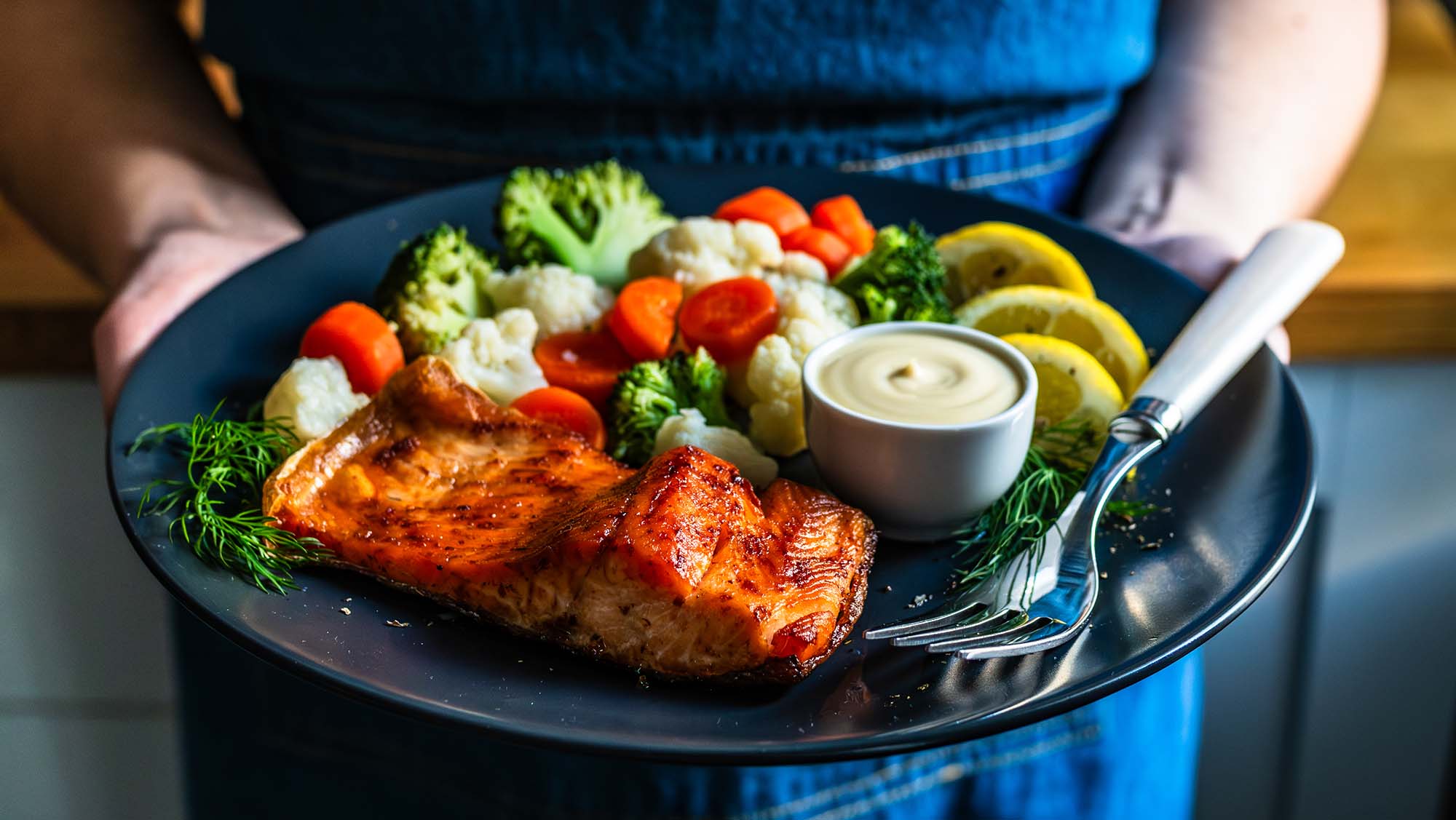 a person holds a plate of food that supports joint health
