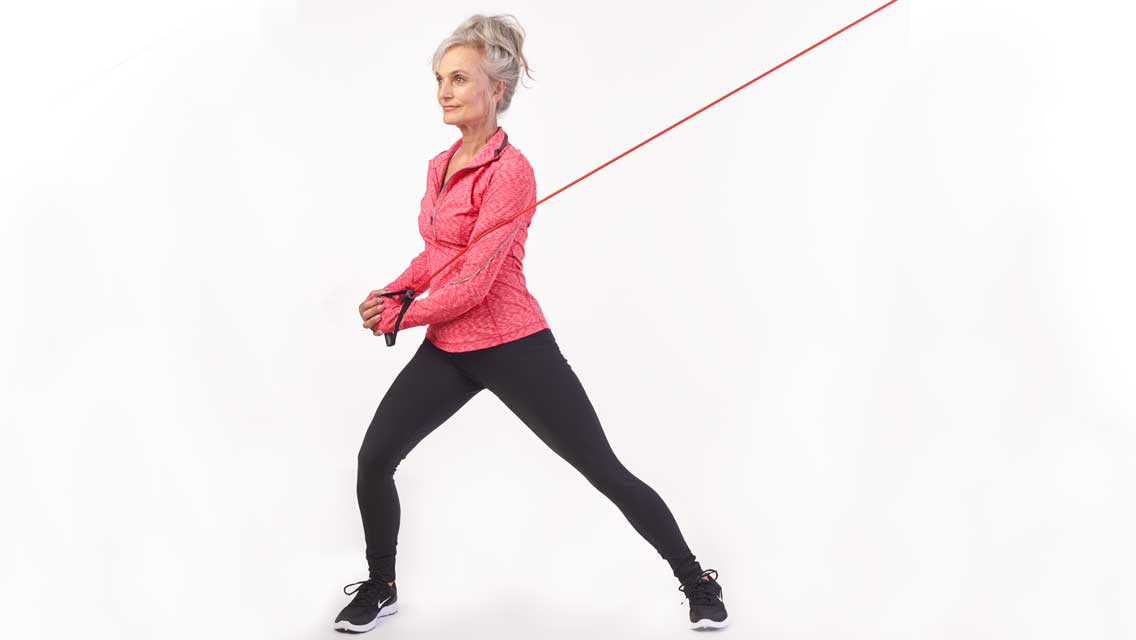 a woman pulls a resistance band