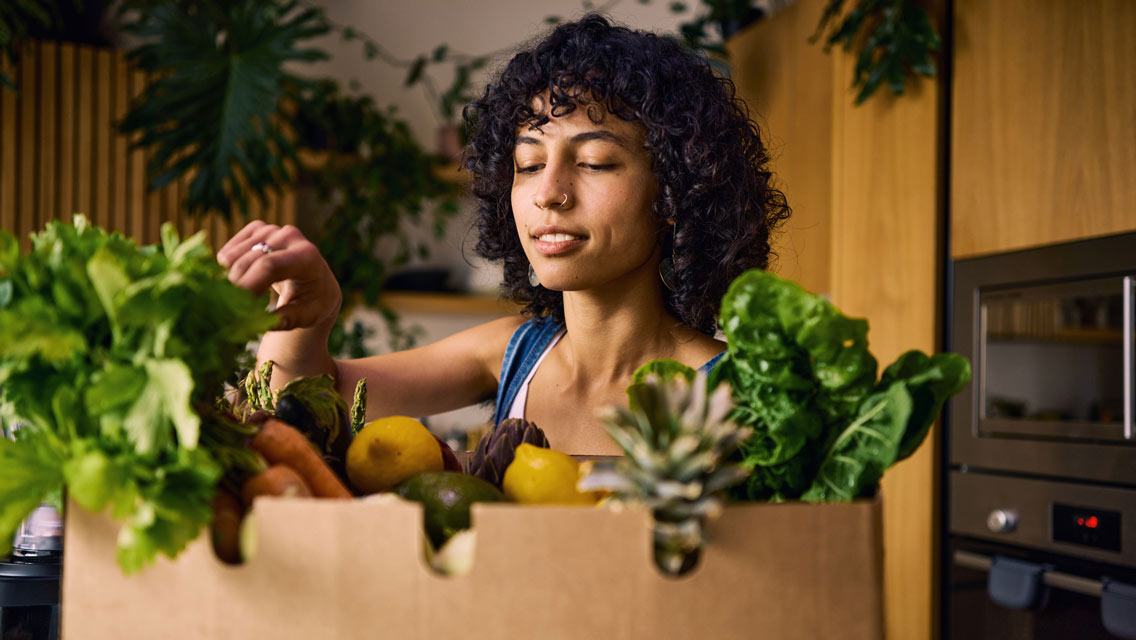 a woman upacking healthy groceries