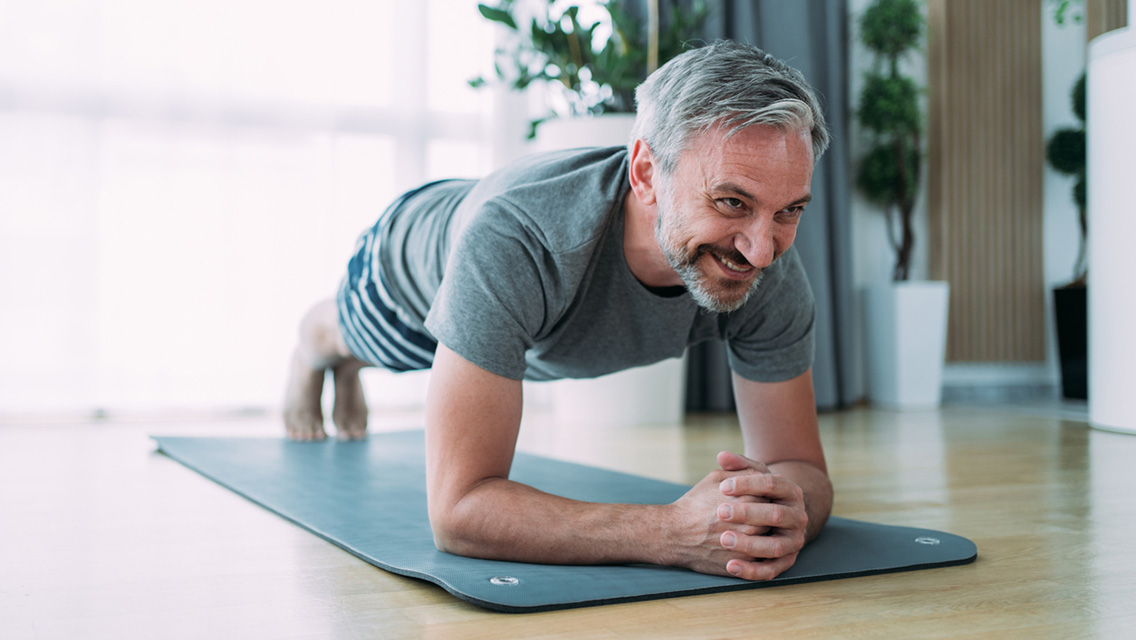 a man hold forearm plank while working out at home