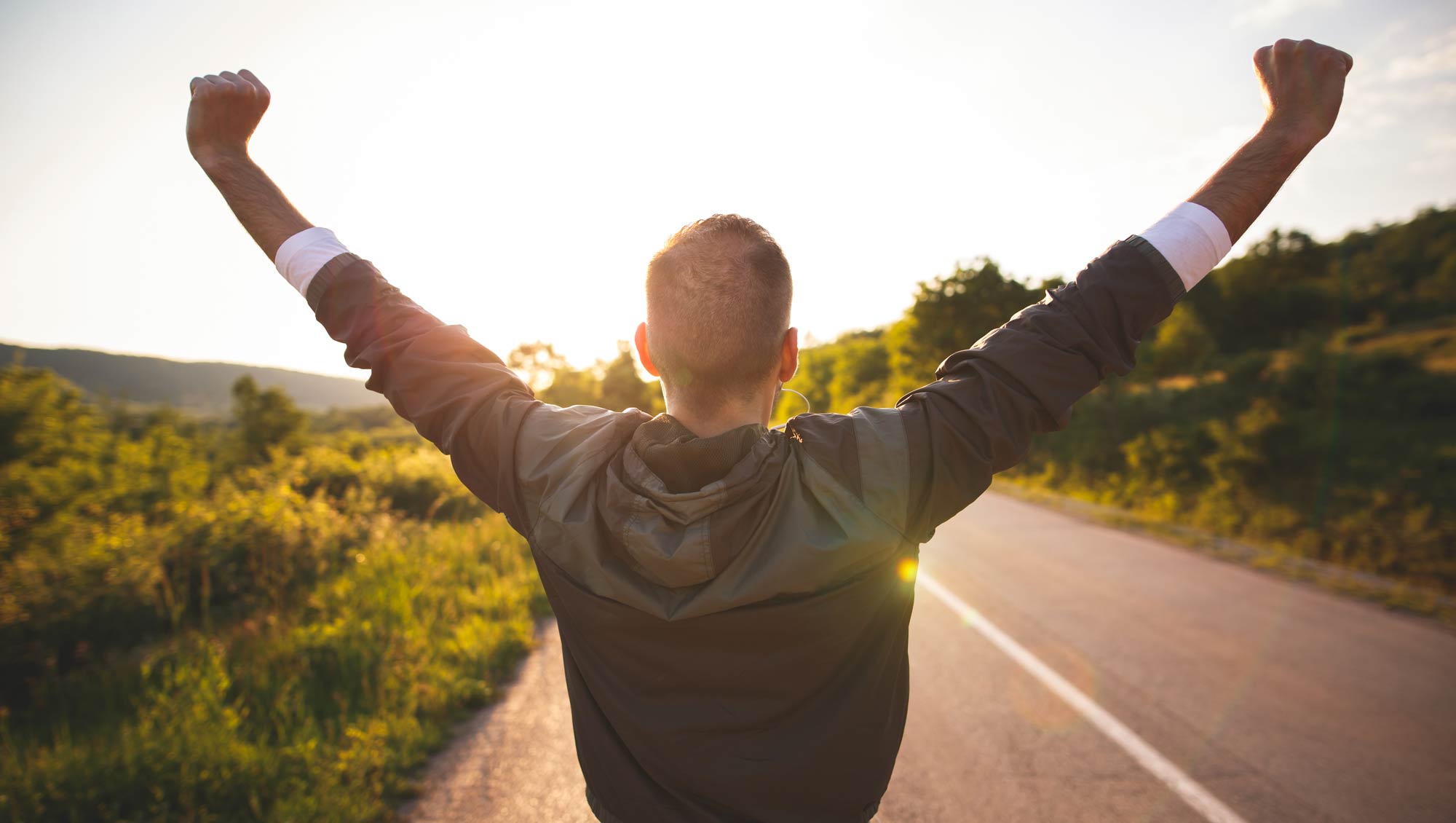 man with arms up