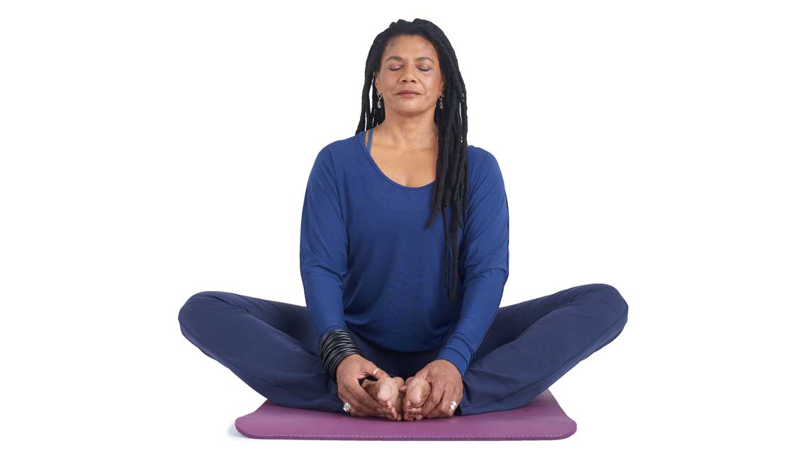 a woman sits in cobblers pose