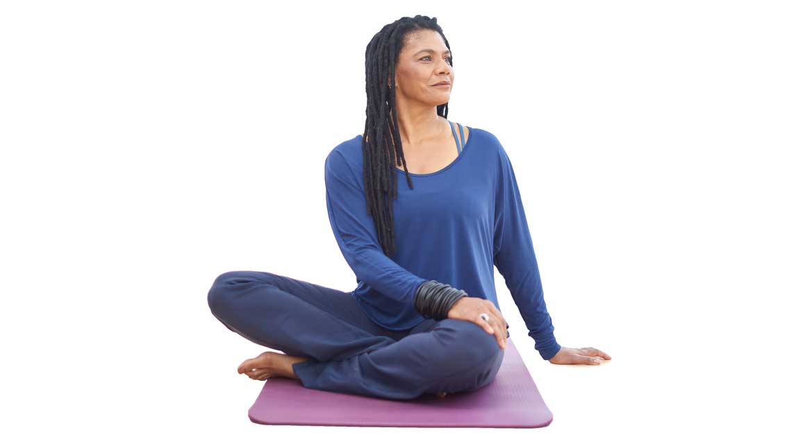 a woman holds seated twist
