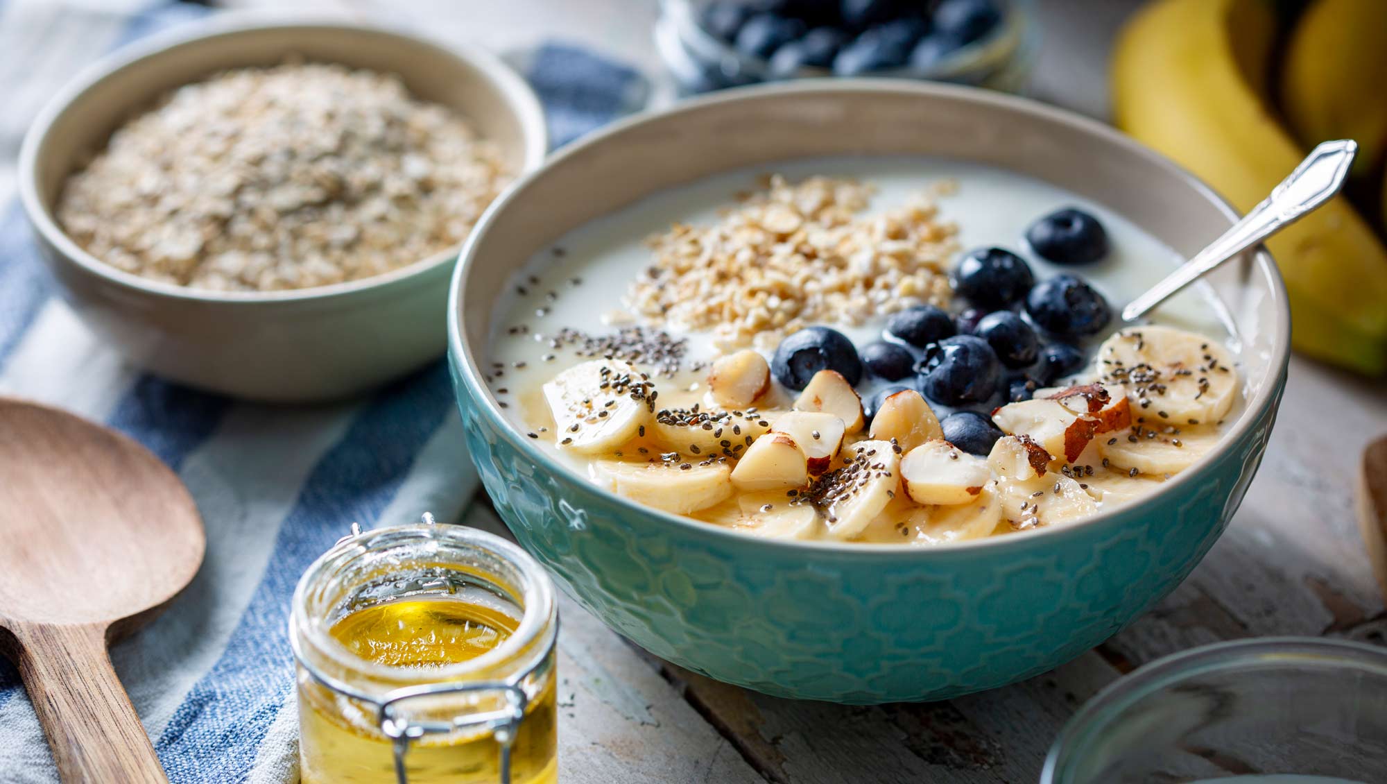 a bowl of oatmeal with nuts, blueberries and chia seeds