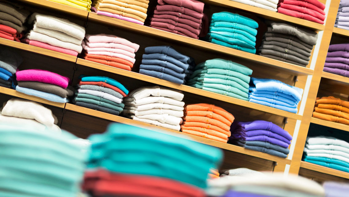 stacks of colorful shirts and sweaters