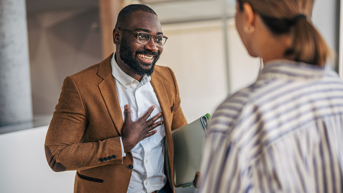 a corporate employee chats with a coworker