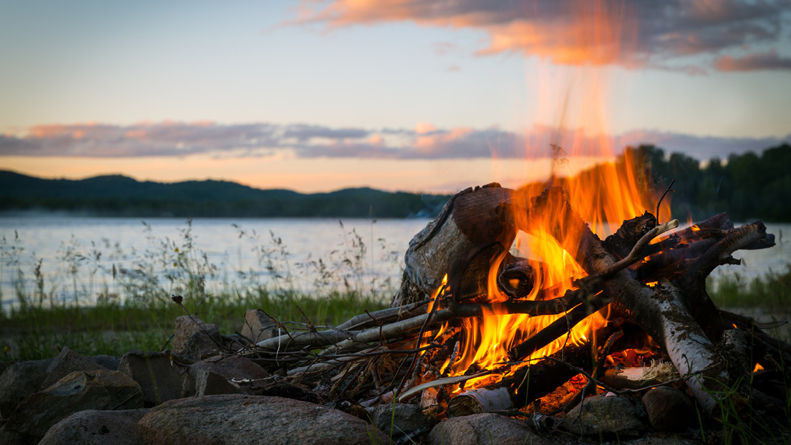 a campfire near a shore line