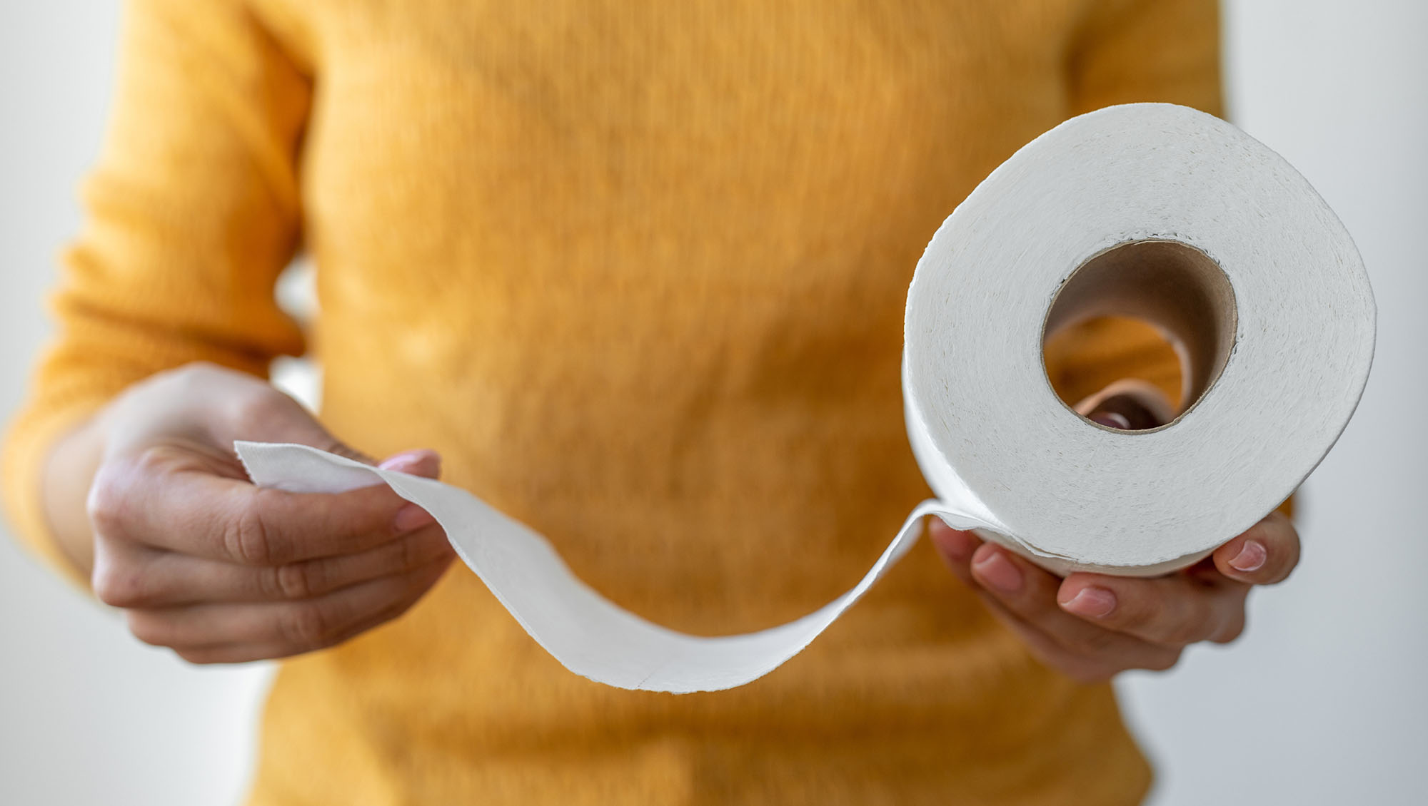 a woman holding toilet paper