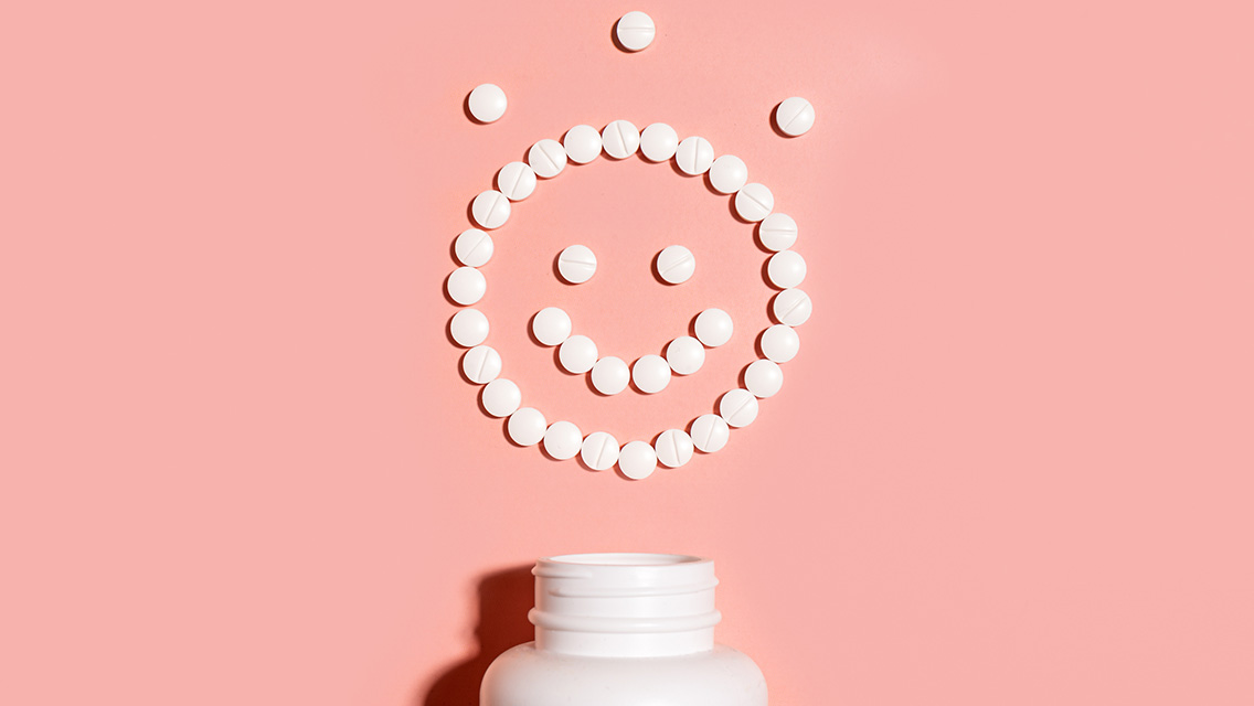 Happy smiling face made of white pills