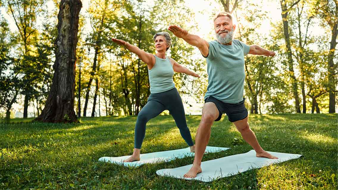 Couple doing yoga outside