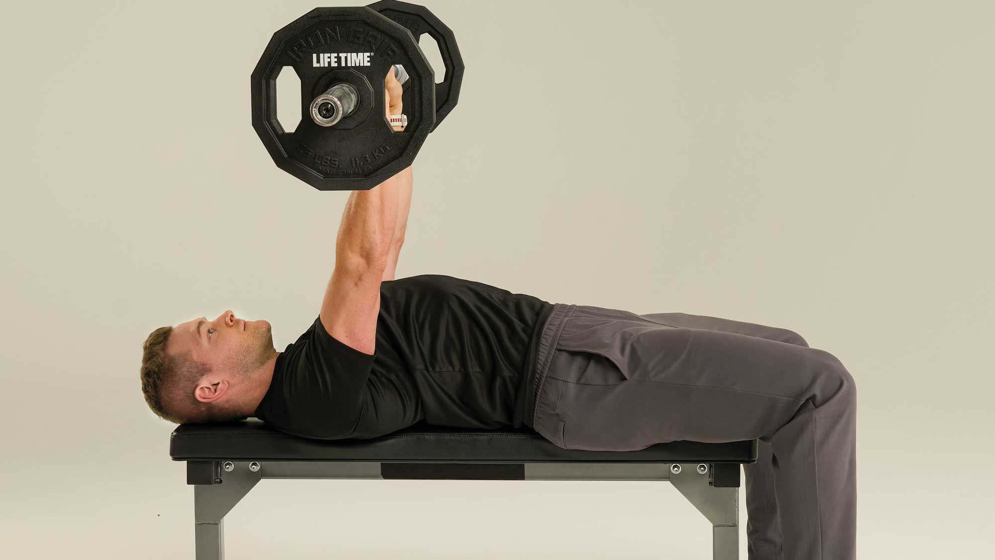 a man performs a chest press