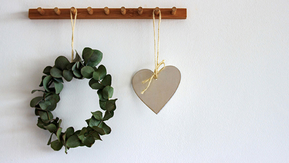 Wreath and wooden heart on wall