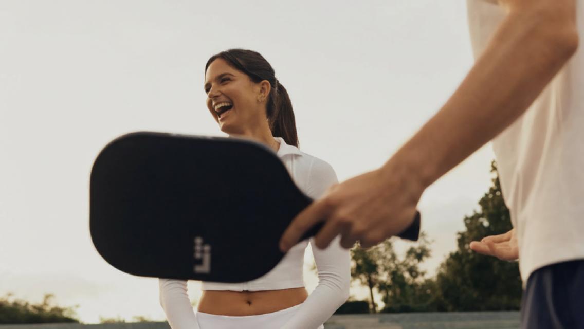 man and woman playing pickleball together