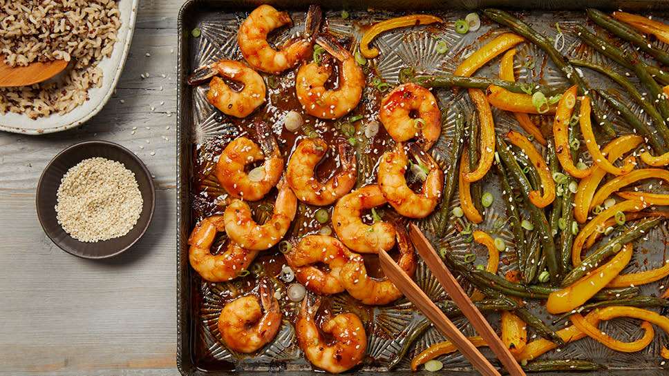Shrimp, green beans and peppers on a sheet pan.