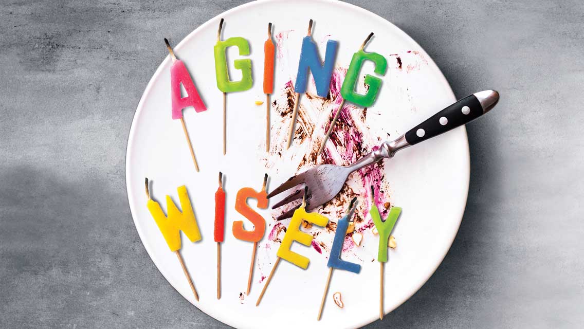 a plate with candles that spell out aging wisely