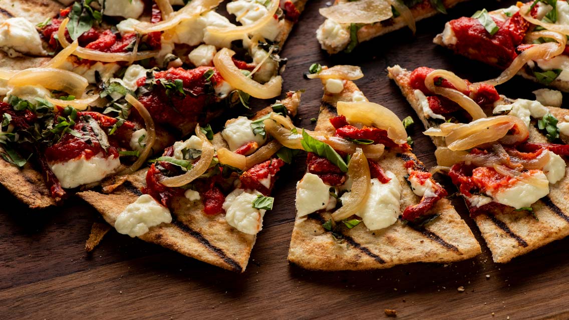 onion, tomato, goat cheese flatbread