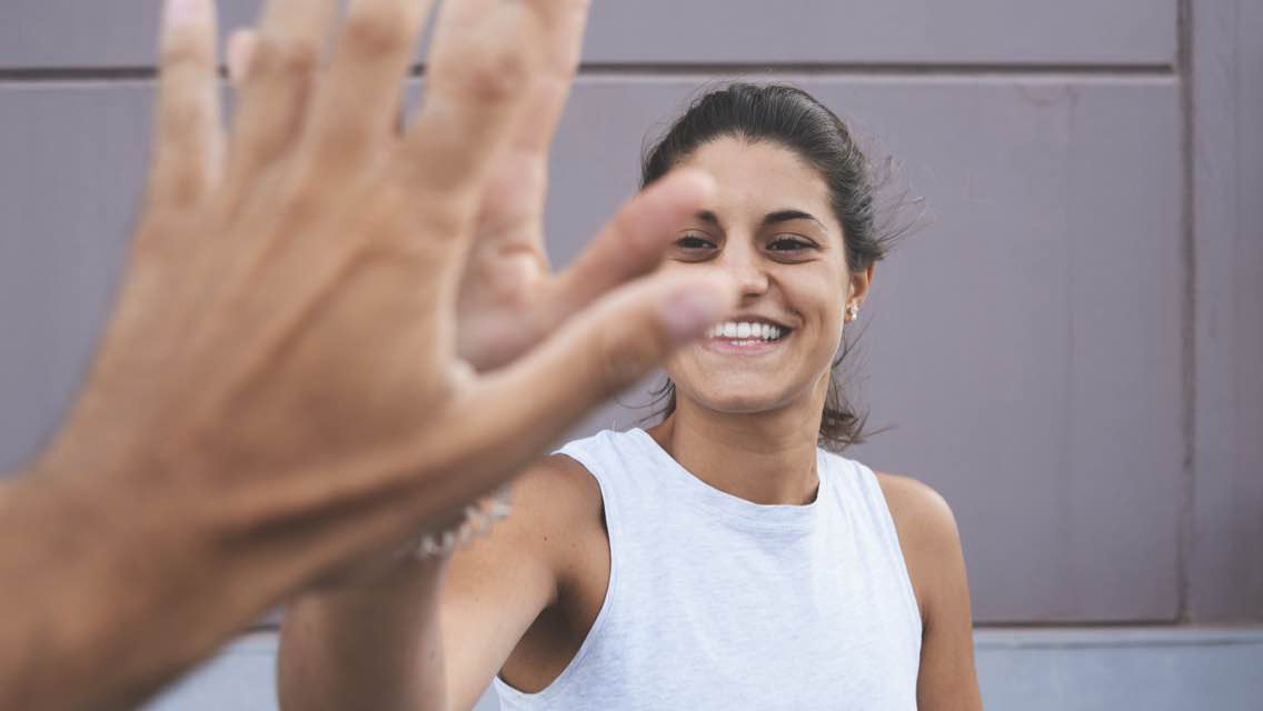 Woman high fiving someone