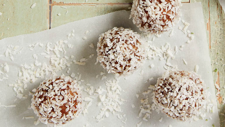 Four coconut-lime energy balls are pictured.