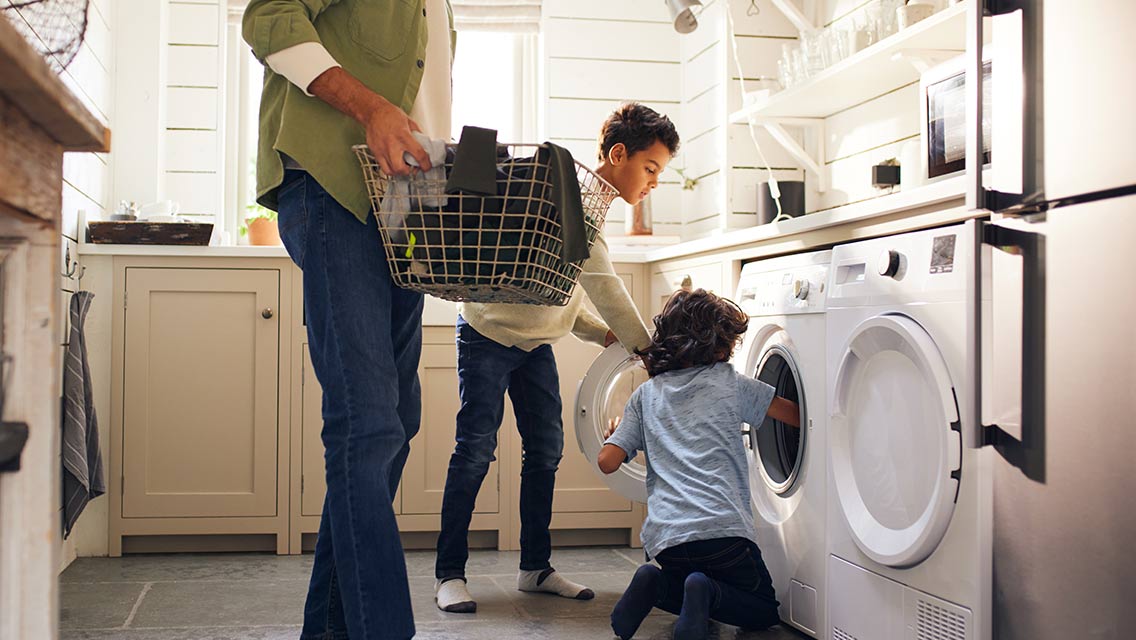 Father and sons doing laundry