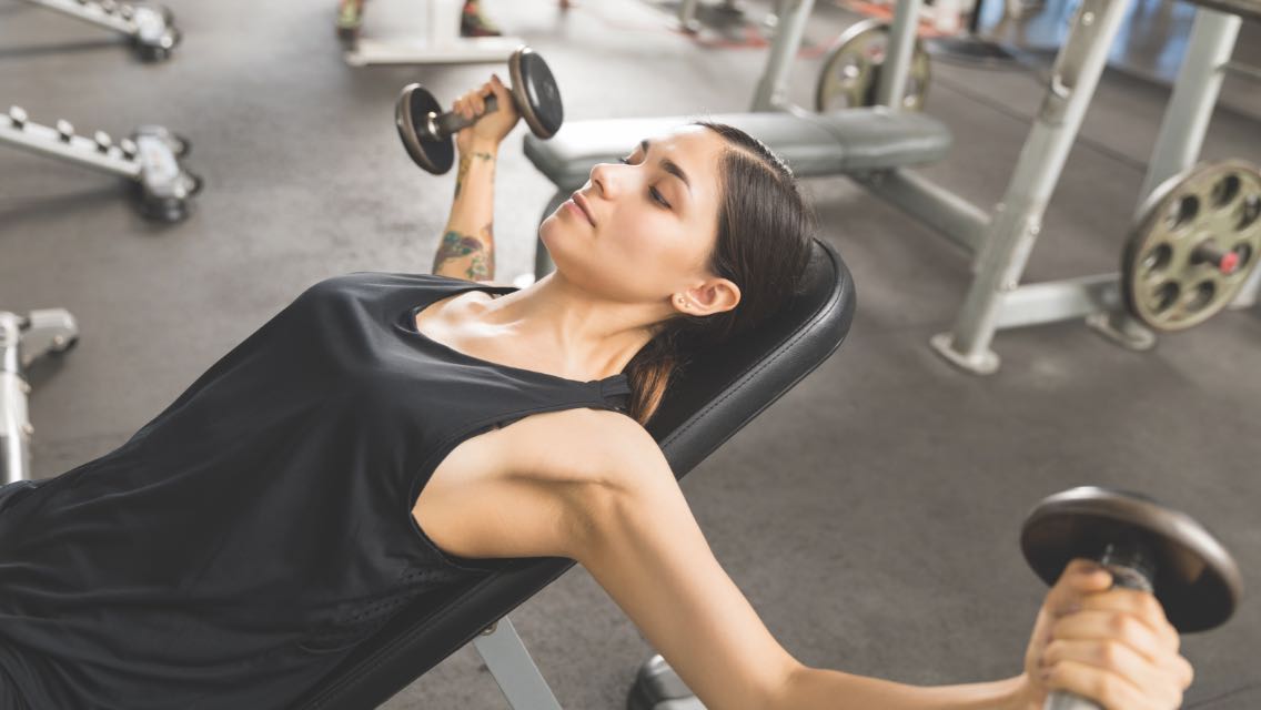 Woman working out with dumbbells.