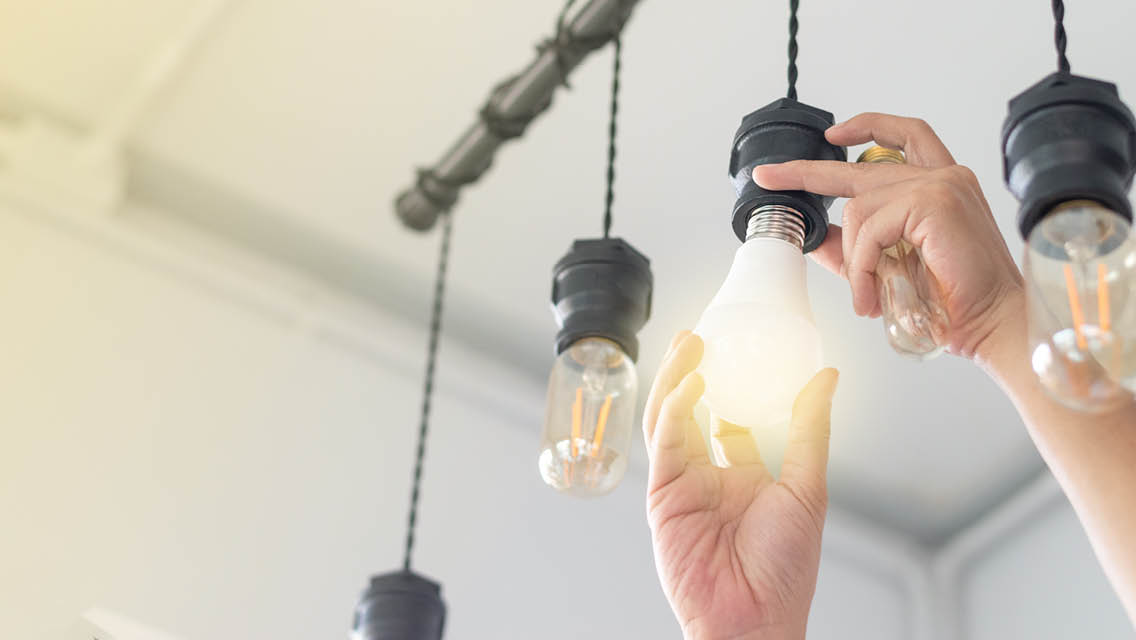 A person changes a light bulb.