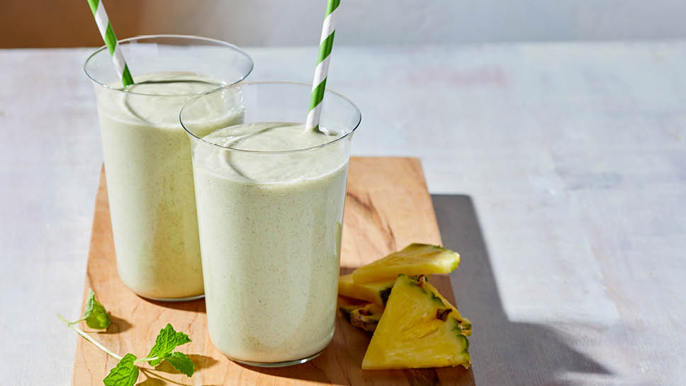 Two glasses of a cucumber and pineapple smoothie.