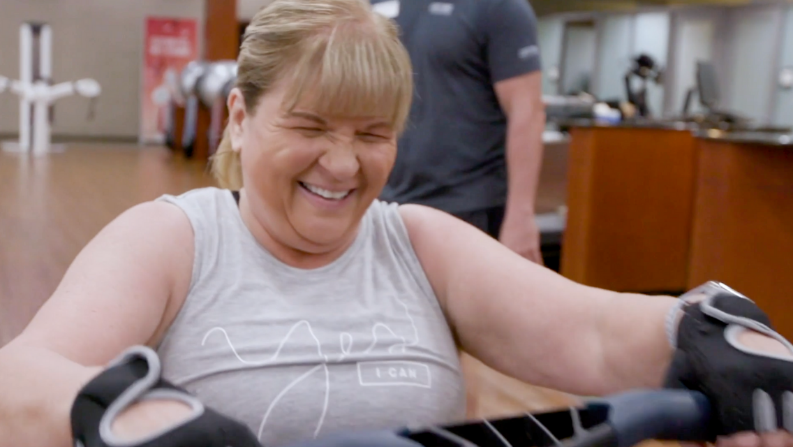Woman in gym smiling