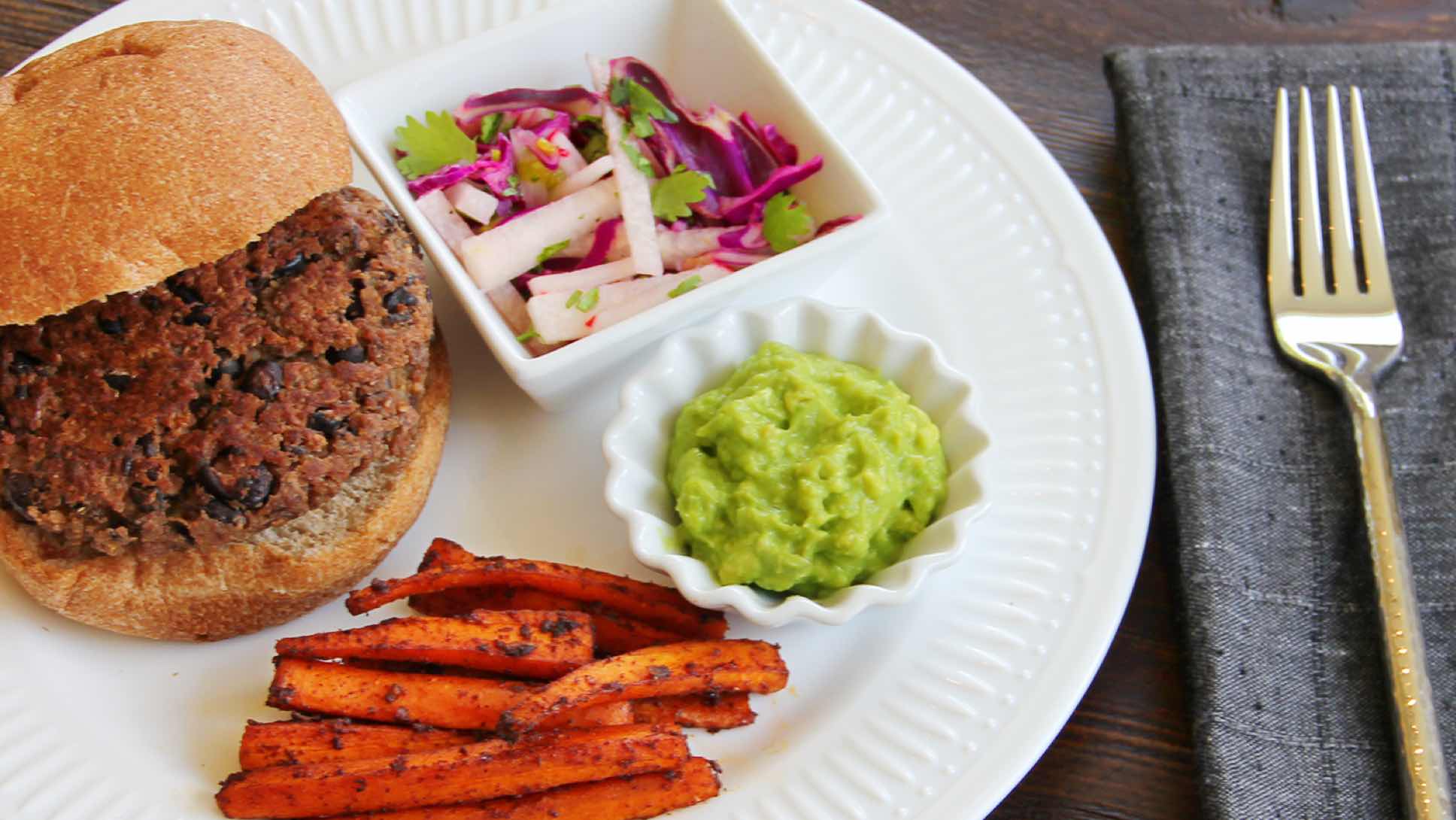 Black bean burger with carrot fries, slaw and guacamole.