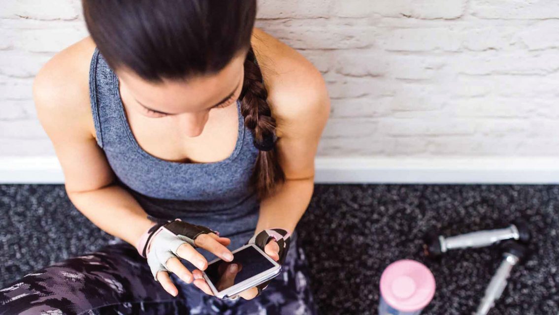 active woman looking at cellphone
