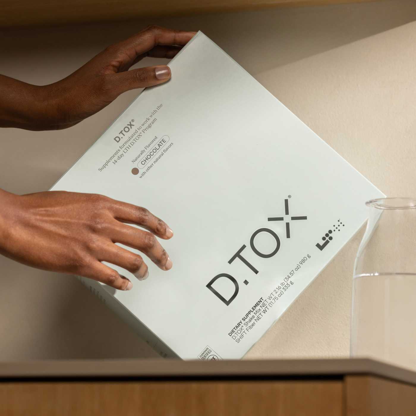 person holding D.TOX box