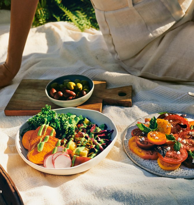 A picnic food spread of whole-food-based dishes.